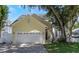 Charming two-story home with a well-maintained lawn and a two-car garage at 6015 S Elkins Ave, Tampa, FL 33611