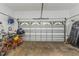An open garage showing an automatic garage door and bikes and storage solutions on a concrete floor at 6015 S Elkins Ave, Tampa, FL 33611