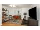 Bright home office with hardwood floors, shuttered windows, and a dedicated exercise area at 6015 S Elkins Ave, Tampa, FL 33611