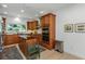 Spacious kitchen boasts custom wood cabinets, a center island with seating, and modern appliances at 6015 S Elkins Ave, Tampa, FL 33611