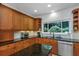 Updated kitchen showcasing custom cabinets, granite countertops, stainless steel appliances, and great natural light at 6015 S Elkins Ave, Tampa, FL 33611