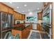 Kitchen with stainless steel appliances, granite countertops, custom cabinets, and a kitchen island at 6015 S Elkins Ave, Tampa, FL 33611