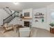 Spacious living area featuring a fireplace, stairs to second story and modern decor at 6015 S Elkins Ave, Tampa, FL 33611