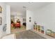 Open-concept living room with dining area, lots of natural light, and hardwood floors at 6015 S Elkins Ave, Tampa, FL 33611