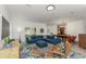 Bright living room featuring a comfortable blue sectional sofa, colorful rug, and natural light at 6015 S Elkins Ave, Tampa, FL 33611