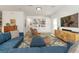 Open living area featuring bright interior, large sofa, bookshelf, and modern accents at 6015 S Elkins Ave, Tampa, FL 33611
