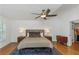 Elegant main bedroom features wood floors, a ceiling fan, and ample natural light at 6015 S Elkins Ave, Tampa, FL 33611