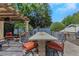 Outdoor dining area featuring a large table, seating for eight, and a built-in grill station at 6015 S Elkins Ave, Tampa, FL 33611
