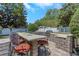 Backyard with outdoor kitchen and grill area featuring a stone counter with seating at 6015 S Elkins Ave, Tampa, FL 33611