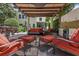 A view of a patio area with a large table with chairs, a full seating set, and a pergola with a built-in bar at 6015 S Elkins Ave, Tampa, FL 33611