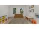 Playroom with soft flooring, storage shelves, a convertible sofa, and lots of natural light at 6015 S Elkins Ave, Tampa, FL 33611