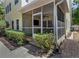 Back of home showing a screened patio, a well maintained yard, and a paved walkway at 6015 S Elkins Ave, Tampa, FL 33611
