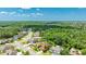Aerial view showing a beautiful home in a neighborhood surrounded by green space and trees at 6111 Horse Mill Pl, Palmetto, FL 34221