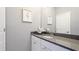 Neutral toned bathroom with a gray countertop, white cabinets, and decorative accents at 6111 Horse Mill Pl, Palmetto, FL 34221