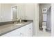Bright bathroom with white cabinets, gray counters, and access to the water closet at 6111 Horse Mill Pl, Palmetto, FL 34221
