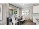 Stylish dining area with seating for six, modern decor, and sliding door access to an outdoor patio at 6111 Horse Mill Pl, Palmetto, FL 34221
