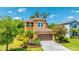 Charming two-story home with lush landscaping and an attached two car garage at 6111 Horse Mill Pl, Palmetto, FL 34221