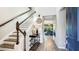 Elegant foyer featuring a staircase, console table, and a view into the living room at 6111 Horse Mill Pl, Palmetto, FL 34221