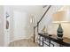 Inviting foyer with light wood floors, decorative table, and white trim at 6111 Horse Mill Pl, Palmetto, FL 34221