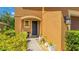 Inviting front entrance with a dark blue door, small plants and shrubbery at 6111 Horse Mill Pl, Palmetto, FL 34221