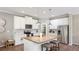 Bright kitchen with white cabinets, a large island, and stainless steel appliances creating a sleek and modern space at 6111 Horse Mill Pl, Palmetto, FL 34221