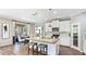 Modern kitchen with an island, stainless steel appliances, and an adjacent dining area with outdoor access at 6111 Horse Mill Pl, Palmetto, FL 34221