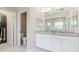 Elegant main bathroom vanity with double sinks, a large mirror, and access to the water closet at 6111 Horse Mill Pl, Palmetto, FL 34221