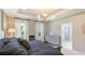 Comfortable main bedroom with a gray color scheme and a view into the main bath at 6111 Horse Mill Pl, Palmetto, FL 34221