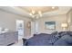 A view of the main bedroom showcases the ensuite bathroom, a mirror, and a statement piece of art at 6111 Horse Mill Pl, Palmetto, FL 34221