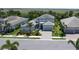 Overhead captures the manicured lawn, gray roof, and the driveway of this well maintained home at 6317 Rivo Lakes Blvd, Sarasota, FL 34241