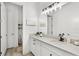 Modern bathroom featuring a white vanity with a quartz countertop, sleek black fixtures, and a neutral color scheme at 6317 Rivo Lakes Blvd, Sarasota, FL 34241