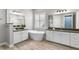 Luxurious bathroom with dual vanities, soaking tub, and elegant fixtures at 6317 Rivo Lakes Blvd, Sarasota, FL 34241