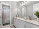 Modern bathroom with a white vanity, a large mirror, and a walk-in shower at 6317 Rivo Lakes Blvd, Sarasota, FL 34241