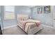 Cozy bedroom featuring a comfortable bed, soft lighting, and tasteful decorations at 6317 Rivo Lakes Blvd, Sarasota, FL 34241