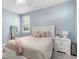Bright bedroom with a plush bed, a white nightstand, and stylish decor at 6317 Rivo Lakes Blvd, Sarasota, FL 34241