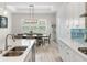 Bright and airy dining area featuring shiplap walls and an elegant chandelier at 6317 Rivo Lakes Blvd, Sarasota, FL 34241