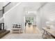Welcoming foyer with view to open living spaces and staircase; features include wood-look floors and shiplap accents at 6317 Rivo Lakes Blvd, Sarasota, FL 34241