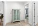 Hallway features a beautiful display cabinet and leads to secondary living space at 6317 Rivo Lakes Blvd, Sarasota, FL 34241