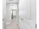 Bright hallway with neutral paint and carpet, showcasing access to multiple rooms at 6317 Rivo Lakes Blvd, Sarasota, FL 34241