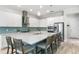Gourmet kitchen with stainless appliances, quartz countertops and backsplash, and a large island at 6317 Rivo Lakes Blvd, Sarasota, FL 34241