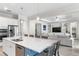 Open kitchen with granite countertops and stainless appliances has great sightlines to the living area at 6317 Rivo Lakes Blvd, Sarasota, FL 34241