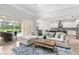 Spacious living room features a large sectional sofa, access to the screened lanai, and open flow to kitchen at 6317 Rivo Lakes Blvd, Sarasota, FL 34241