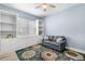 Cozy living room featuring built-in shelving, storage, a neutral sofa, and a decorative rug, ideal for relaxation at 6317 Rivo Lakes Blvd, Sarasota, FL 34241