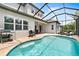 A refreshing screened pool area features a pool, lounge chairs, and an outdoor grilling station at 6317 Rivo Lakes Blvd, Sarasota, FL 34241