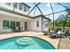 Inviting screened pool with lounge chairs and outdoor dining area, perfect for relaxation and entertaining at 6317 Rivo Lakes Blvd, Sarasota, FL 34241