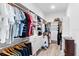 Spacious walk-in closet with custom shelving, drawers, and ample storage space at 6317 Rivo Lakes Blvd, Sarasota, FL 34241