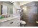 Updated bathroom featuring a marble vanity and walk-in shower with glass door at 7301 12Th W Ave, Bradenton, FL 34209