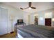 Cozy bedroom featuring a ceiling fan, television, and access to an en-suite bathroom at 7301 12Th W Ave, Bradenton, FL 34209