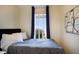 Cozy bedroom with a comfortable bed, accent drapes and natural light at 7301 12Th W Ave, Bradenton, FL 34209