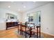 Elegant dining area with a glass-top table, decorative mirror, and ample natural light at 7301 12Th W Ave, Bradenton, FL 34209